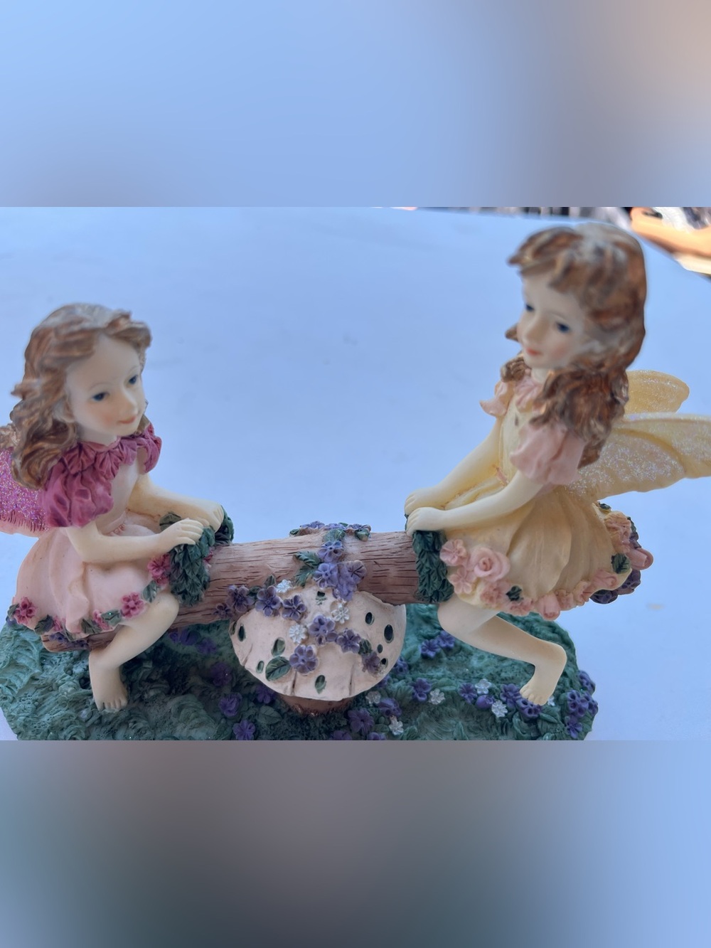 Porcelain Seesaw Fairy Figurine with Purple Floral Accents
